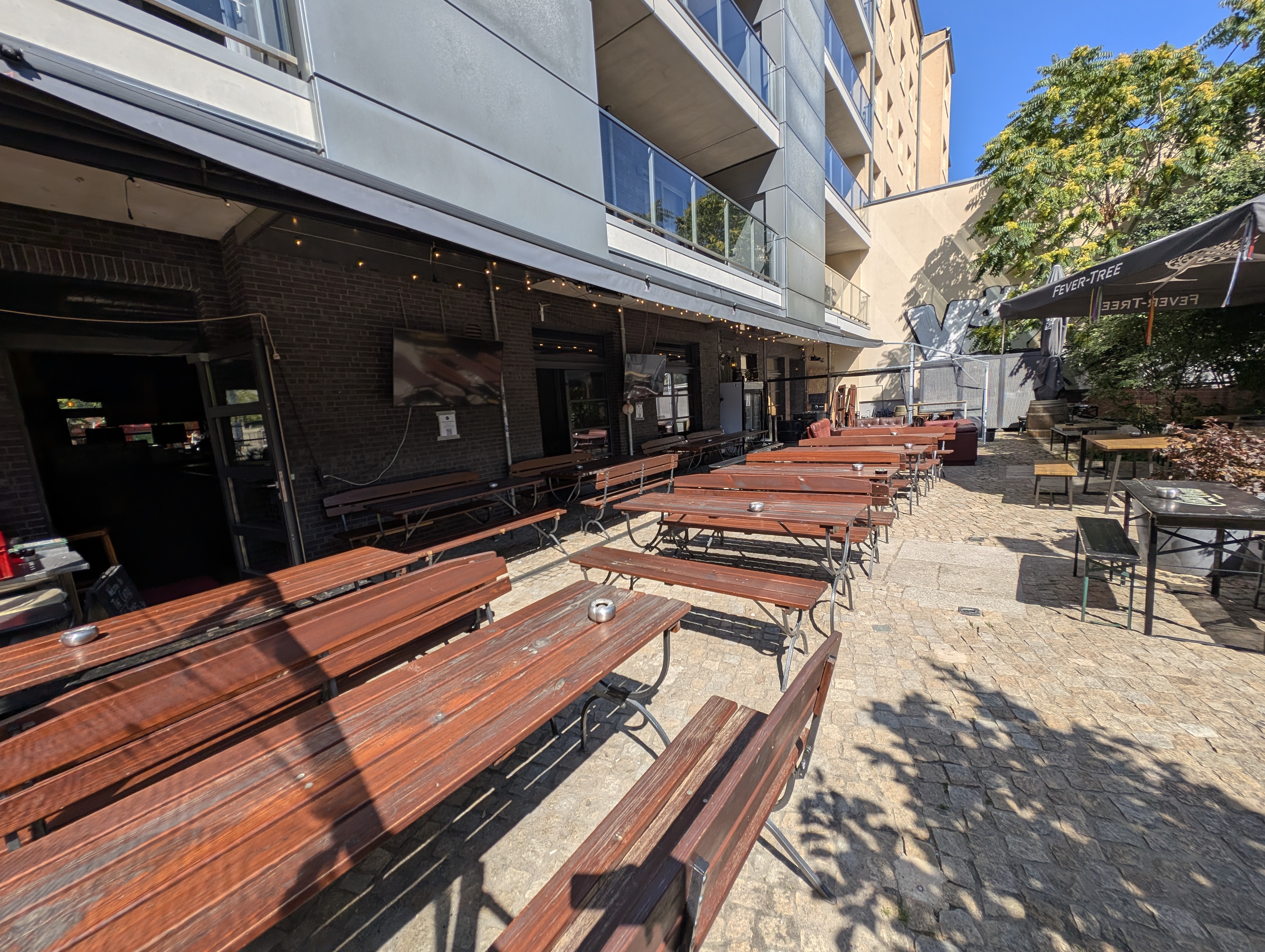 The CASTLE beer garden in Berlin Mitte, with picnic tables and a covered courtyard